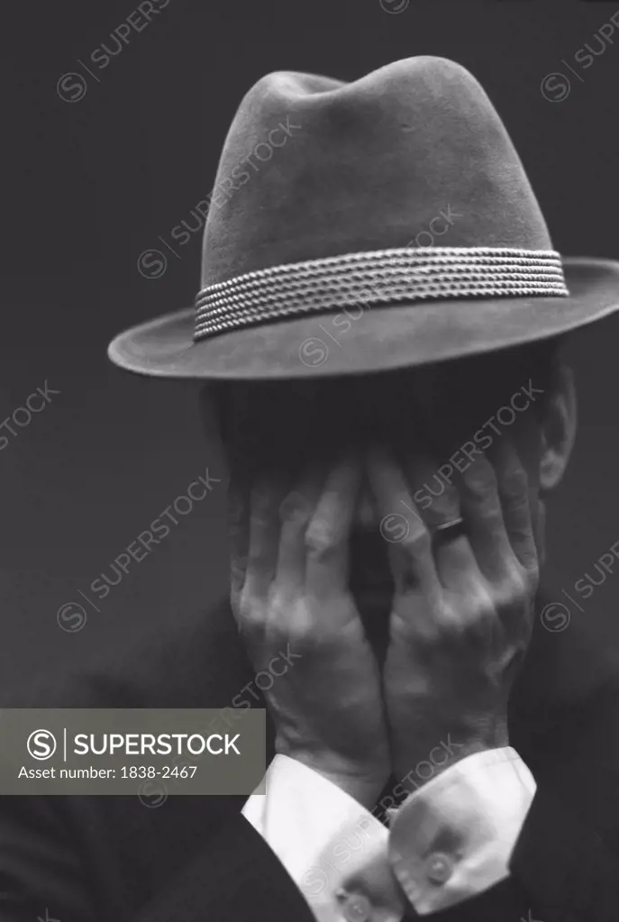 Distressed Man in Hat