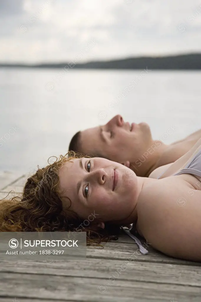 Young Couple Resting on Pier 