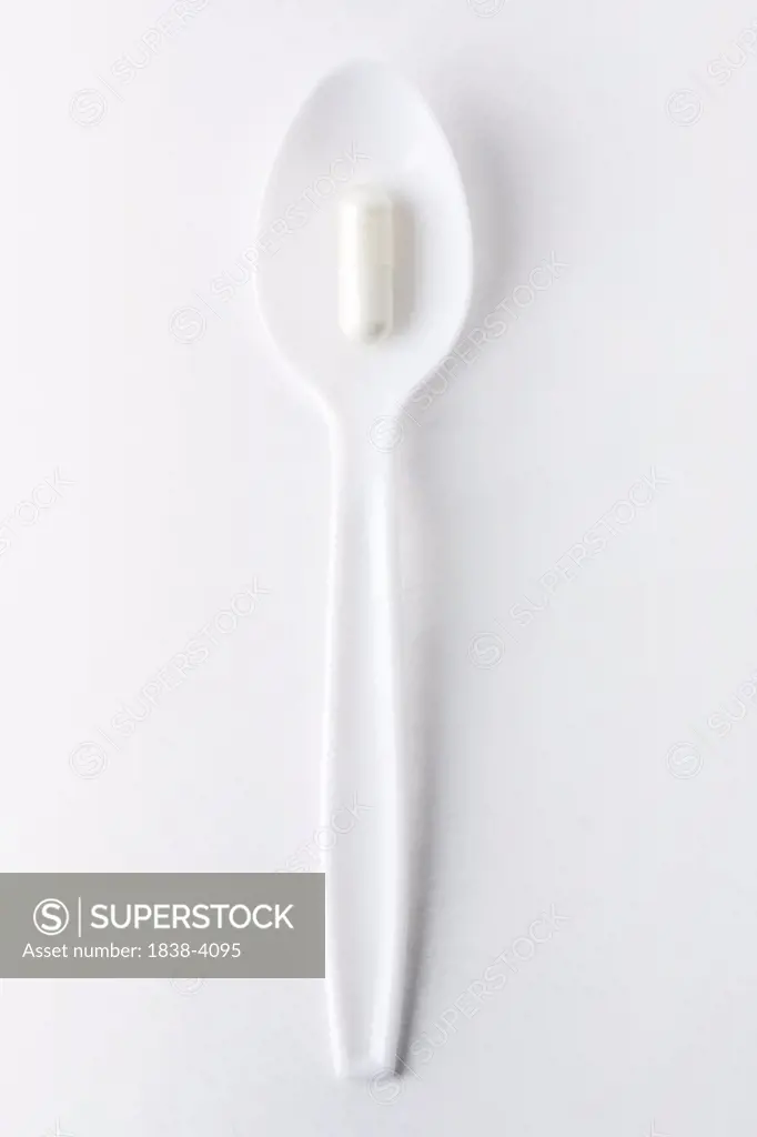Single Pill on Plastic Spoon 