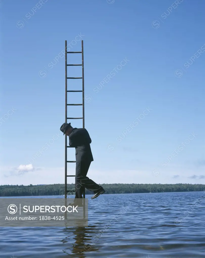 Man Hanging on Ladder in the Water