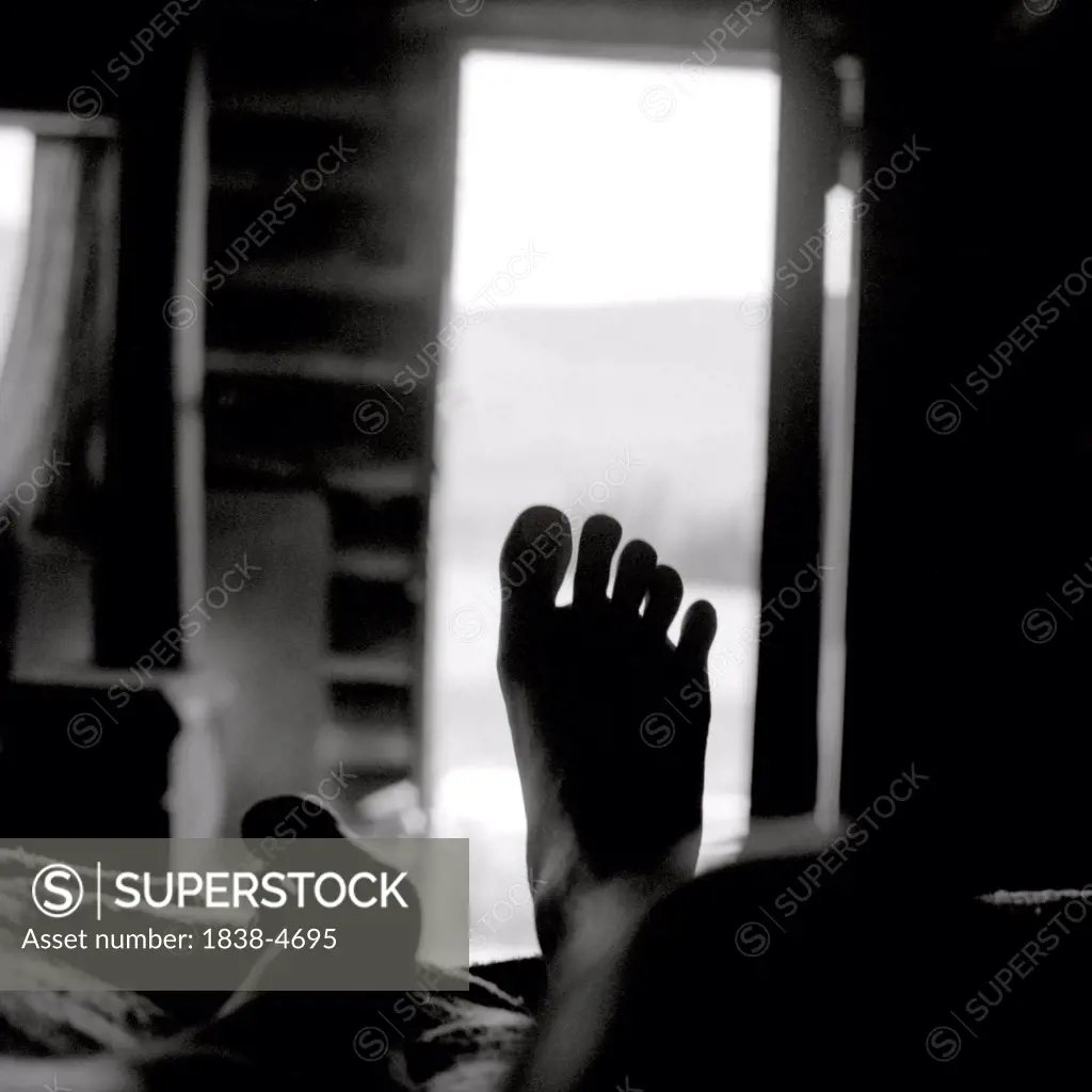 Foot Silhouetted by Open Door