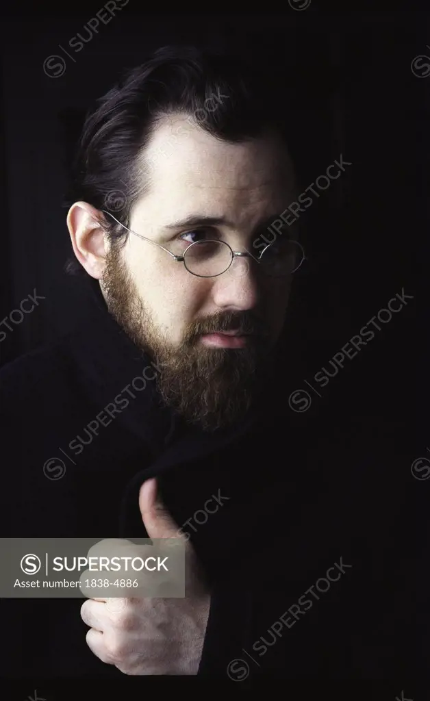 Bearded Man with Glasses in Dark