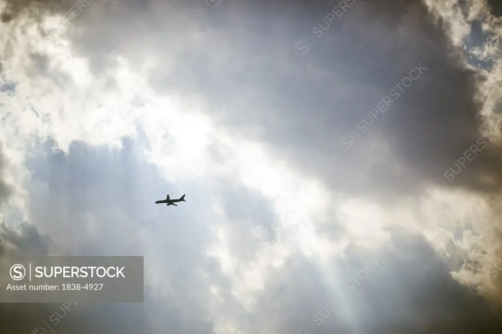 Plane Flying Under Heavenly Light