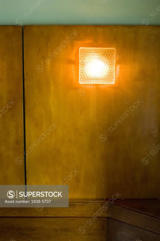 Glass lamp on a wooden panel