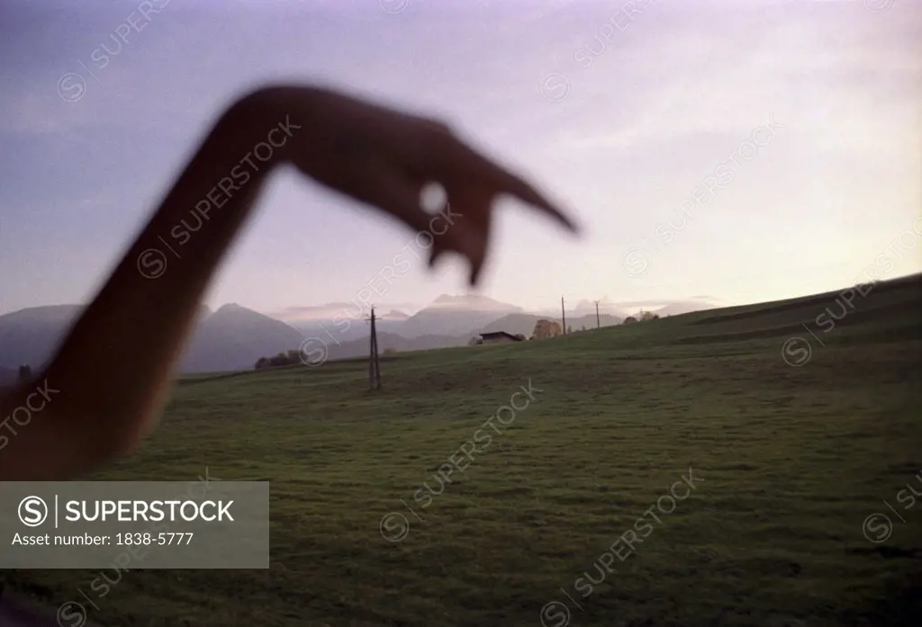 Hand in a mountain scenery