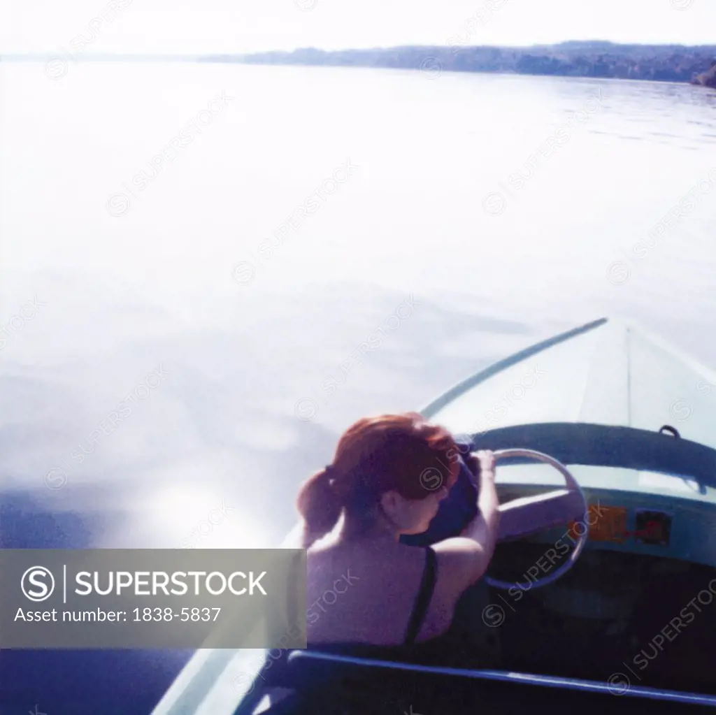 Woman steering a boat