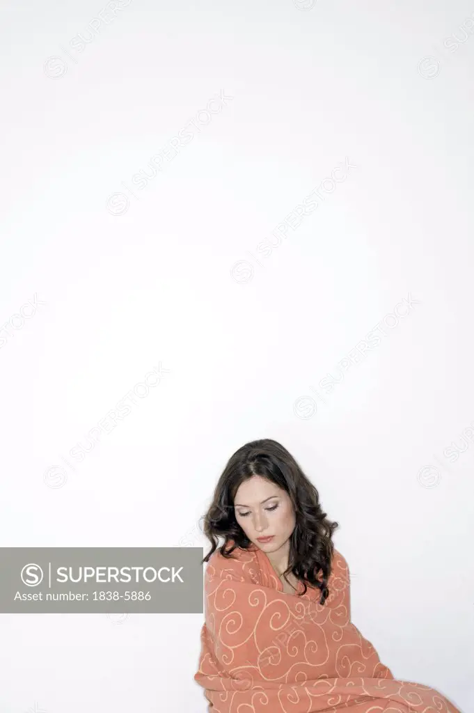 Young woman wrapped in coverlet