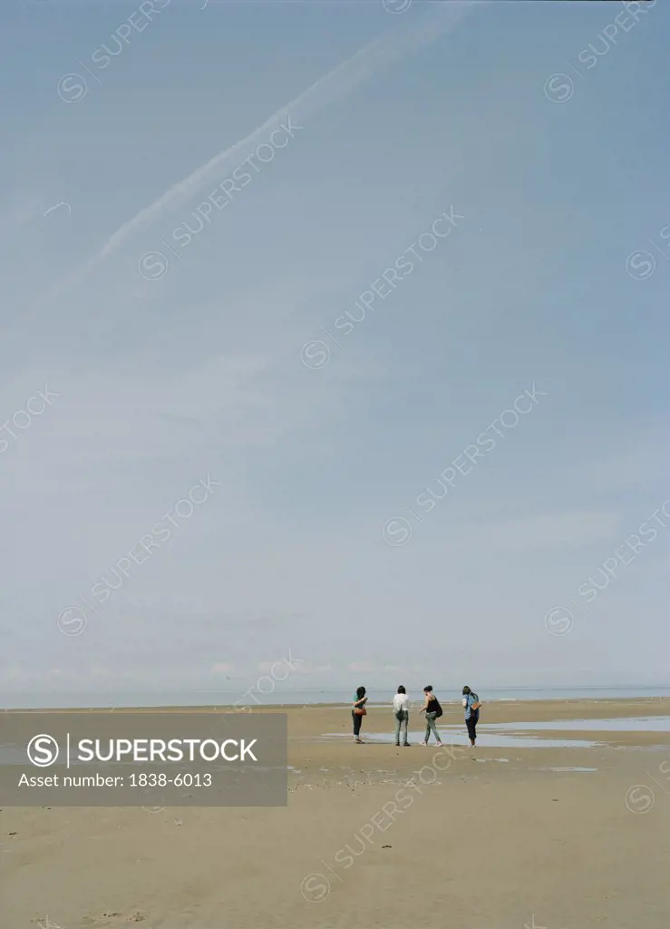 Four people on the beach, Blackpool, England