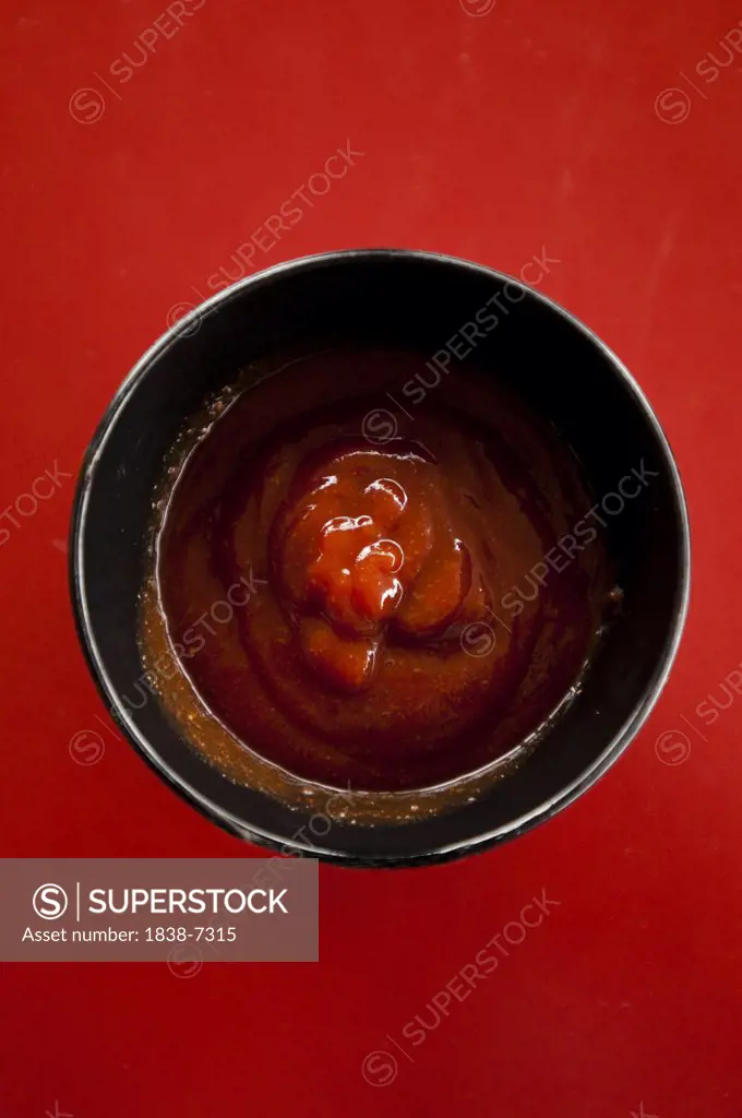 Cup of Barbecue Sauce on Red
