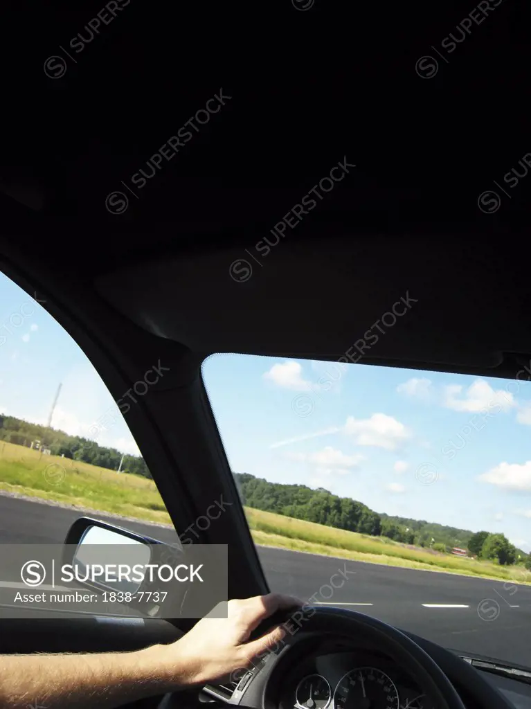 Man Driving Car With View of Landscape