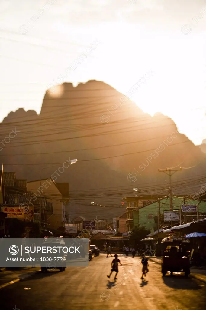 Sun Setting over Street Scene in Vang Vien, Laos