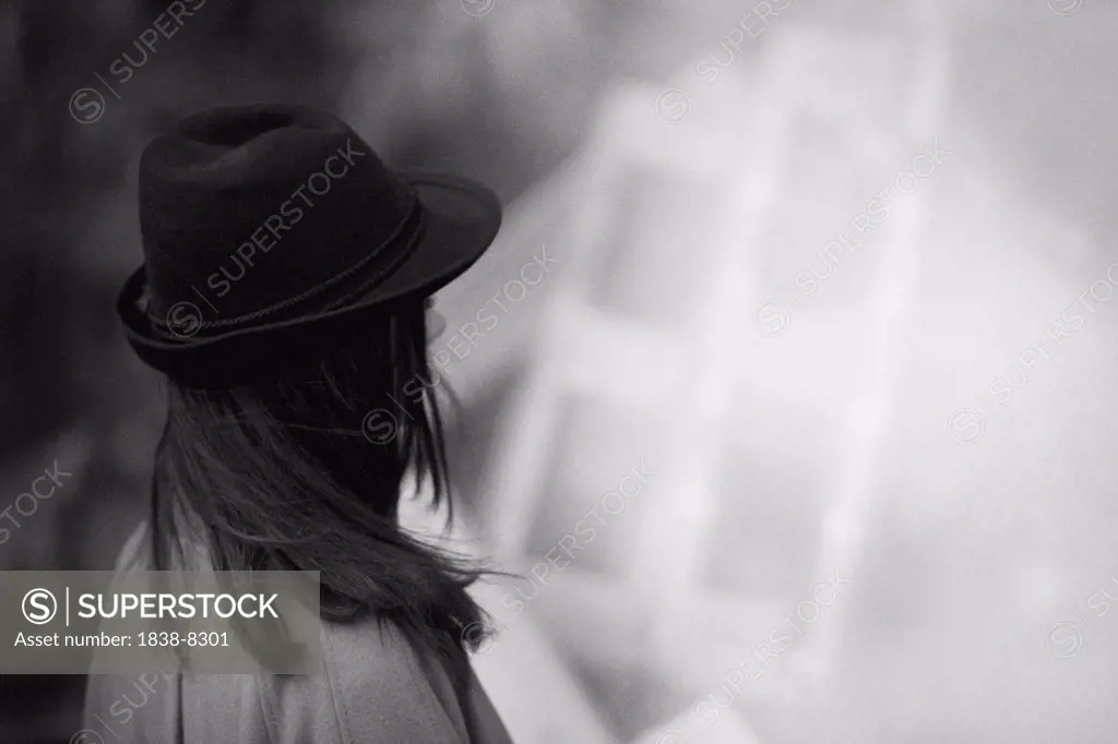 Young Woman Looking Away Wearing Black Hat With Brim