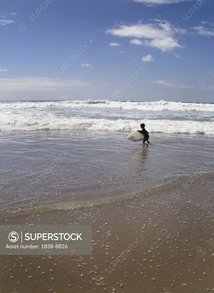 Young Boy Surfing at the Beach