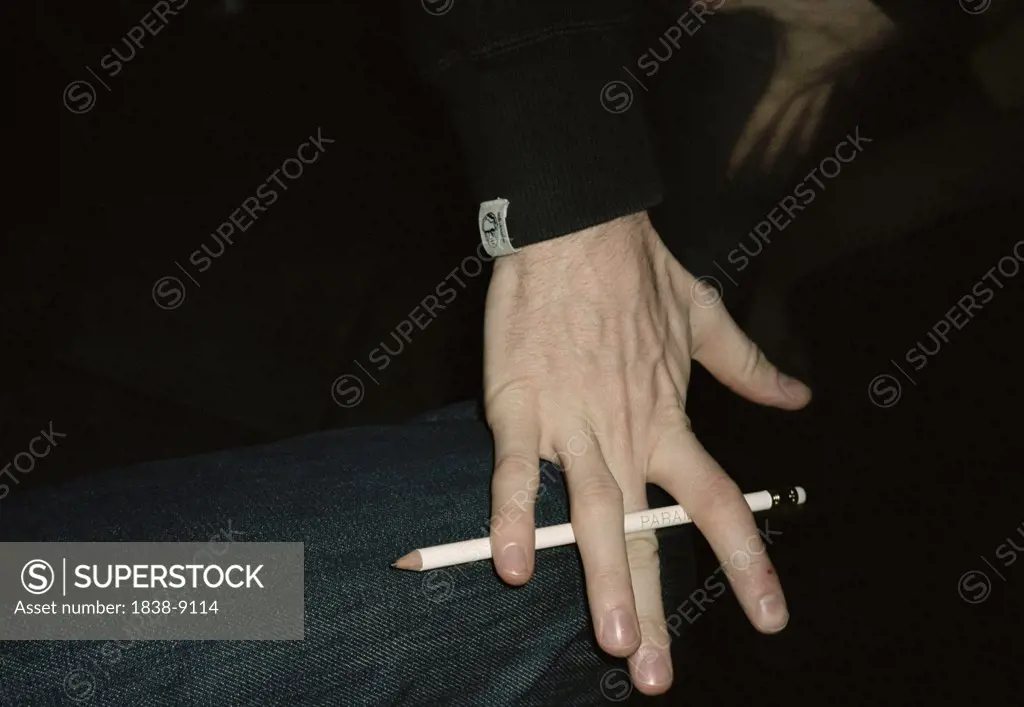 Man Holding Pencil Between Fingers