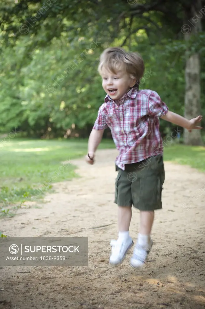 Smiling Young Boy Jumping