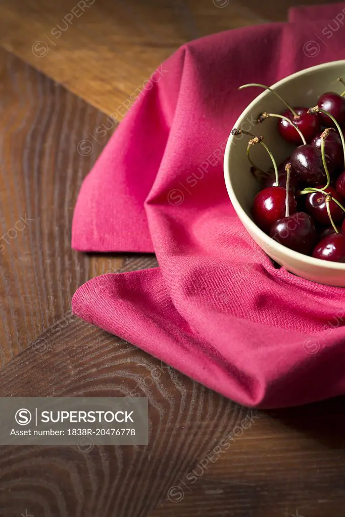 Red Cherries in Bowl on Magenta Tablecloth