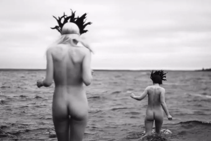 Two Nude Women Wearing Masks Entering Sea