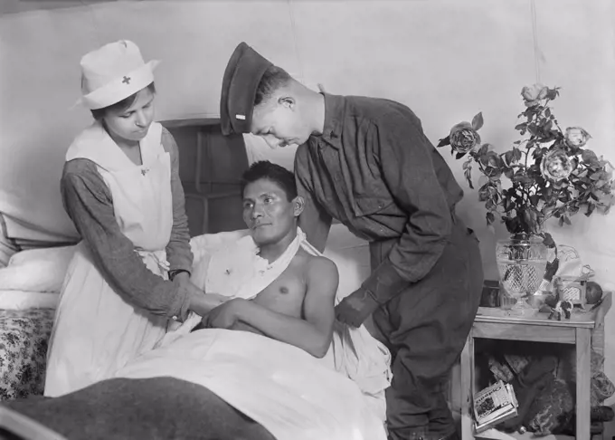 Wounded American Soldier, a Choctaw Native American from Oklahoma, being tended to by Surgeon and Nurse at American Military Hospital No. 5, a Tent Hospital supported by American Red Cross, Auteuil, France, Lewis Wickes Hine, American National Red Cross Photograph Collection, September 1918