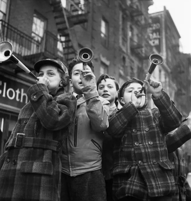 Four Boys blowing horns on New Year's Day, Bleecker Street, New York City, New York, USA, Marjory Collins, U.S. Office of War Information/U.S. Farm Security Administration, January 1943