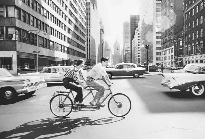 Couple riding Tandem Bicycle, Park Avenue and 57th Street, New York City, New York, USA, Angelo Rizzuto, Anthony Angel Collection, May 1959