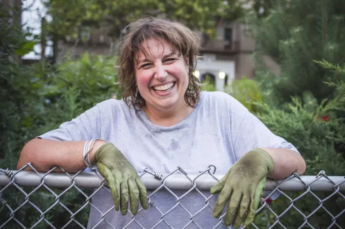 Smiling Gardener Leaning on Fence