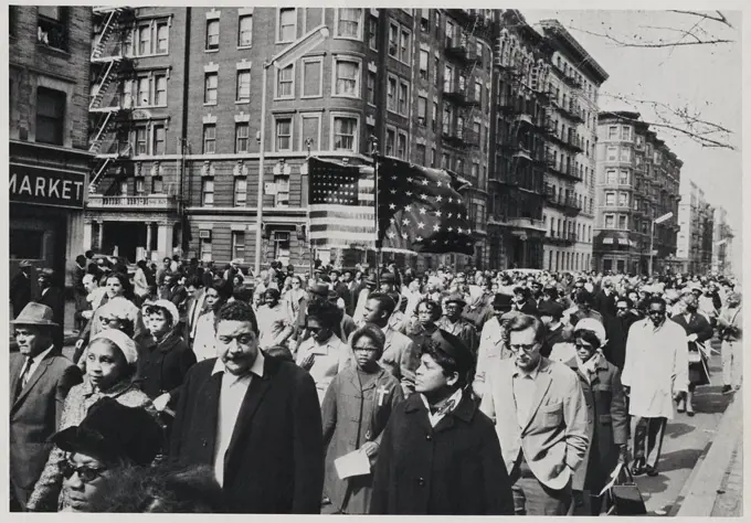 Crowd of Mourners, some Carrying Flags, Marching down 7th Avenue near 112th Street on way to Attend Memorial Service for Dr. Martin Luther King Jr. in Central Park, New York City, New York, USA, April 7, 1968