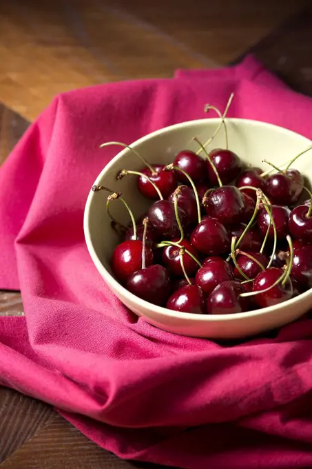 Red Cherries in Bowl on Magenta Tablecloth