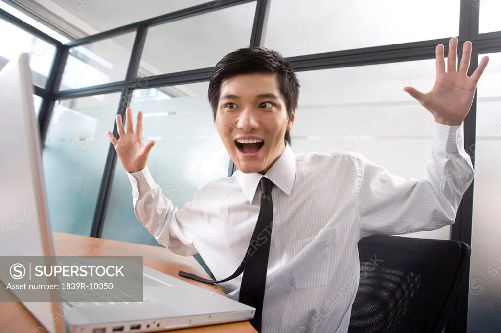 Young businessman get surprised by laptop
