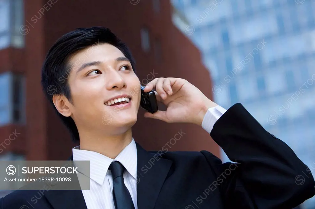 Young businessman using cellphone
