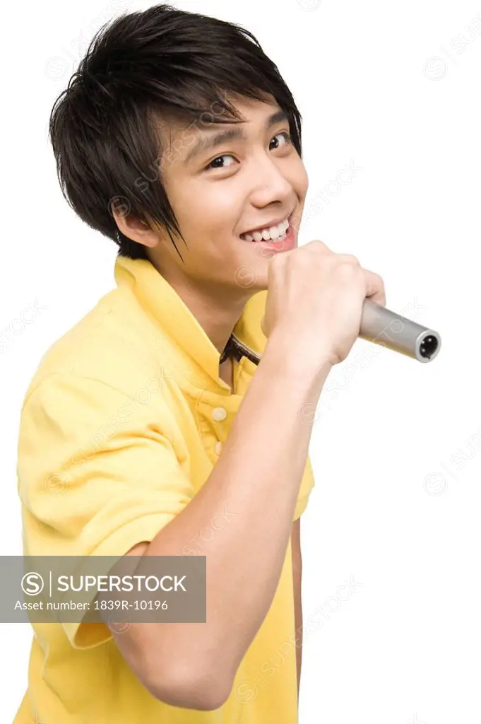 Young man singing with microphone