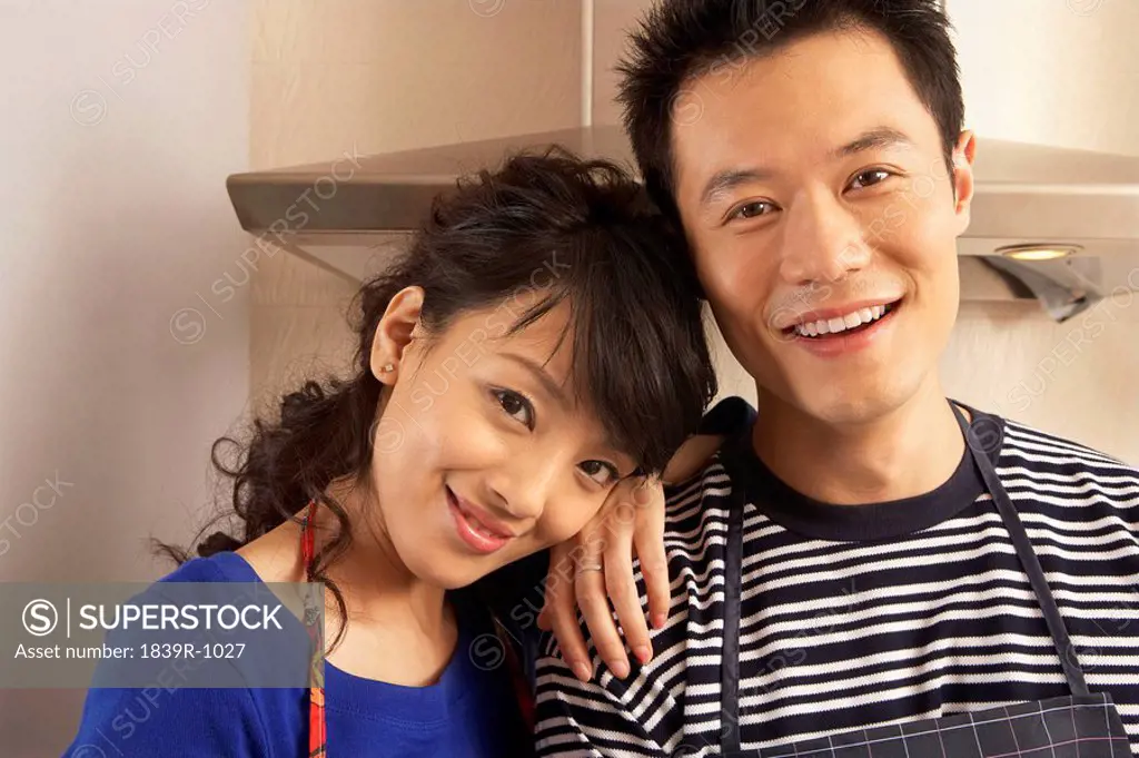 Young Couple Smiling In Their Kitchen