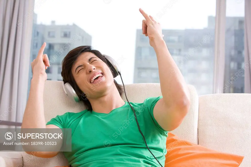 Asian man listening to music