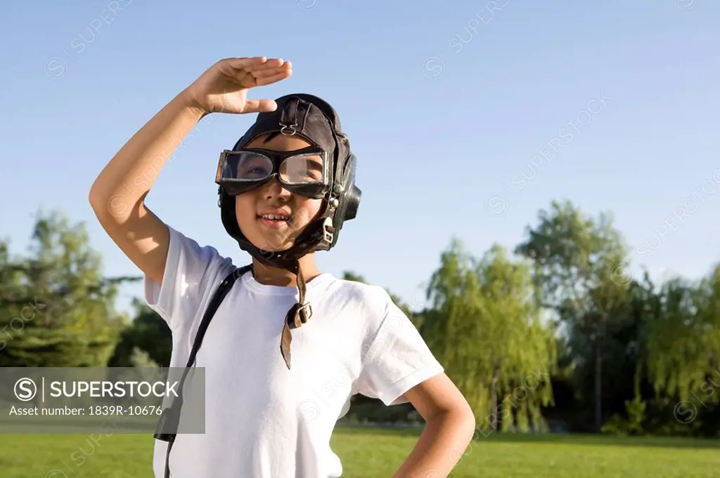 Young boy playing airplane pilot