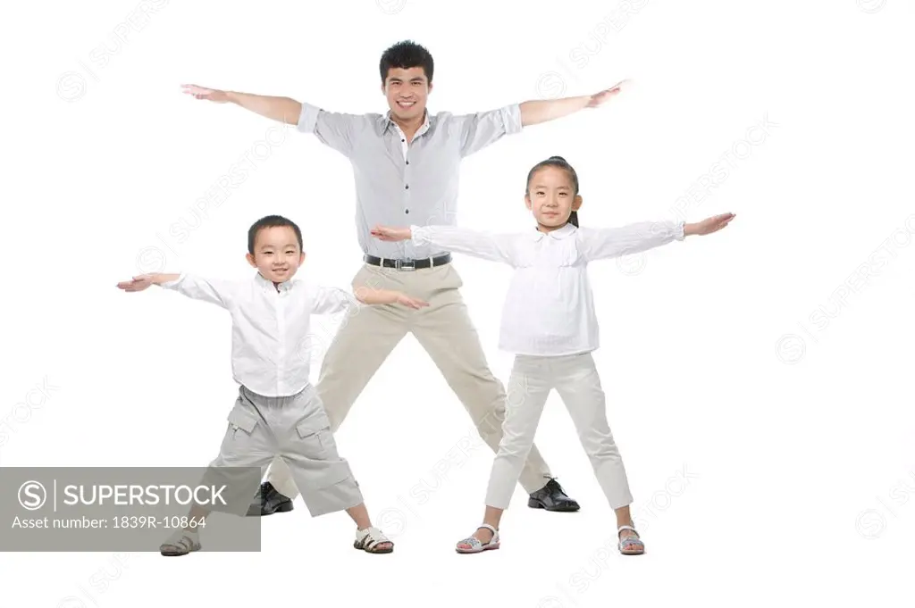 Father and children arms outstretched
