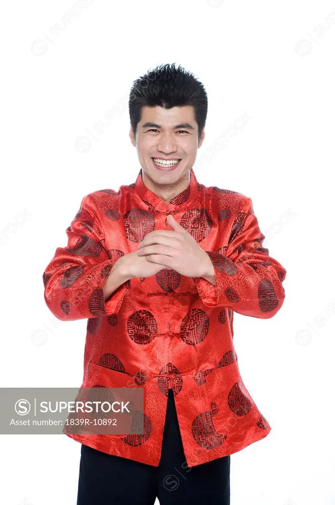 Young man in Chinese traditional clothes giving best wishes