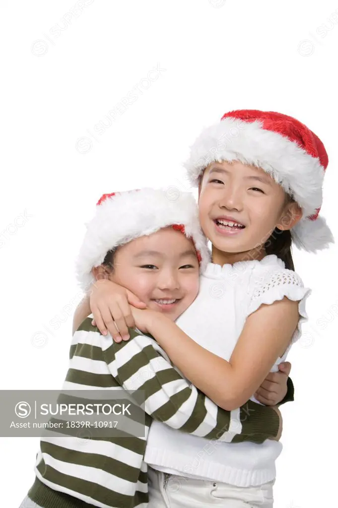 Boy and girl with Santa hats