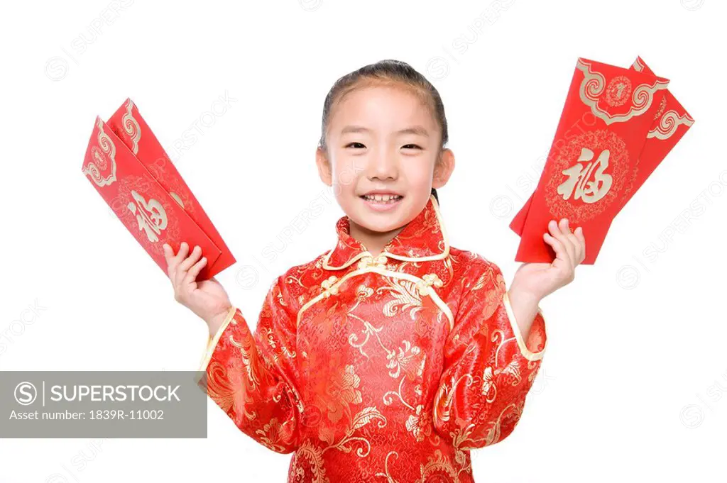 Girl in Chinese traditional clothes holding red envelope