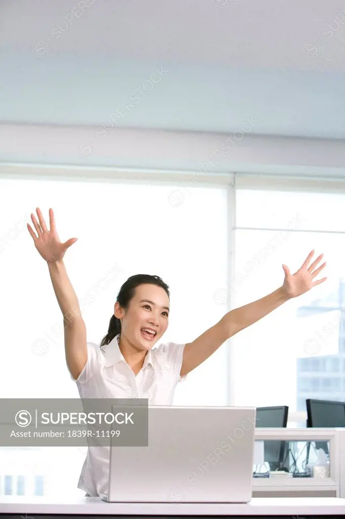 Happy office worker at her desk