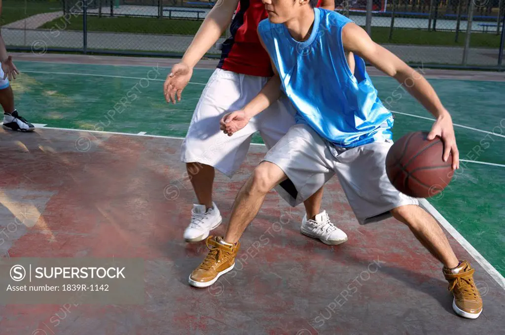Young Men Playing Basketball