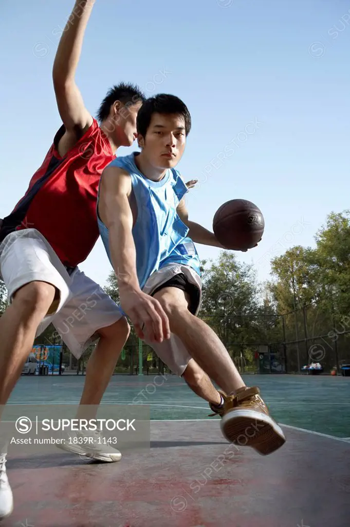 Young Men Playing Basketball