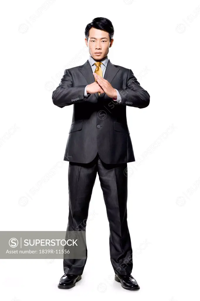 Businessman using hands to greet on white background