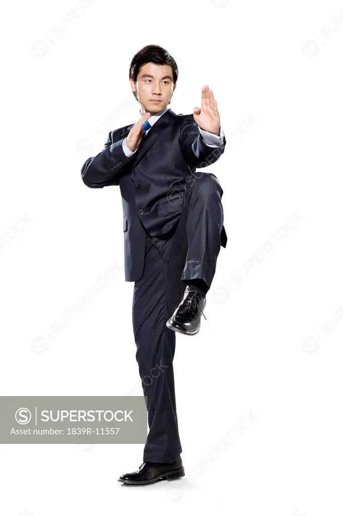 Businessman in fighting stance with hands up