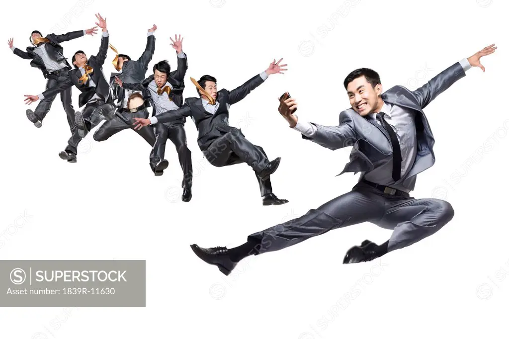 Businessmen jumping and flipping in the air