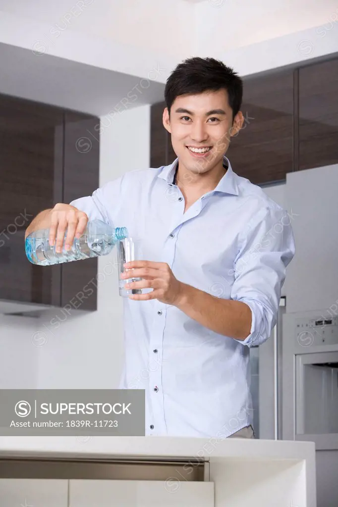 Man pouring a glass of water