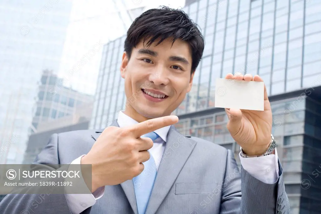 Businessman pointing a card