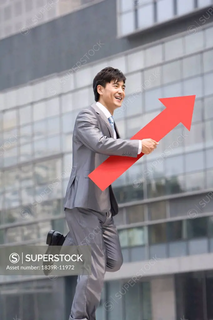 Chinese businessman with a red arrow