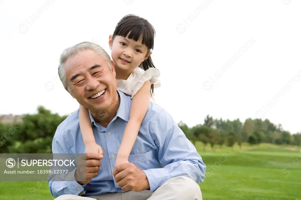 Grandfather and granddaughter enjoy a day at the park