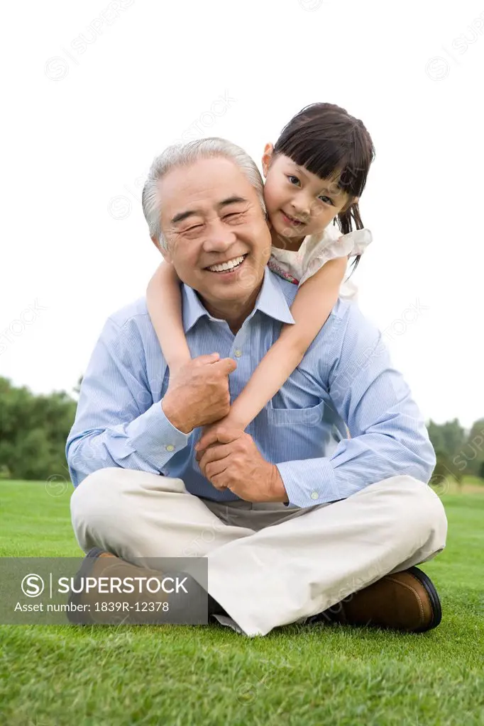 Grandfather and granddaughter enjoy a day at the park