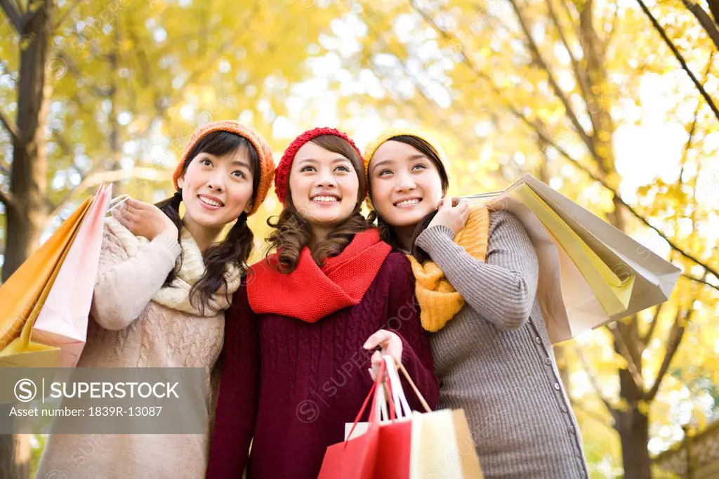 Friends in a Park with Shopping Bags