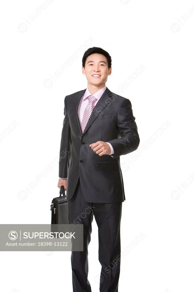 Businessman walking with brief case in hand